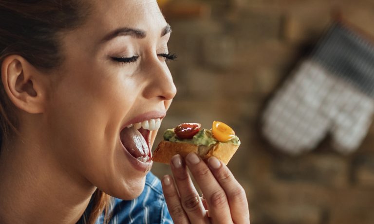 young woman eyes closed mouth open bruschetta 768
